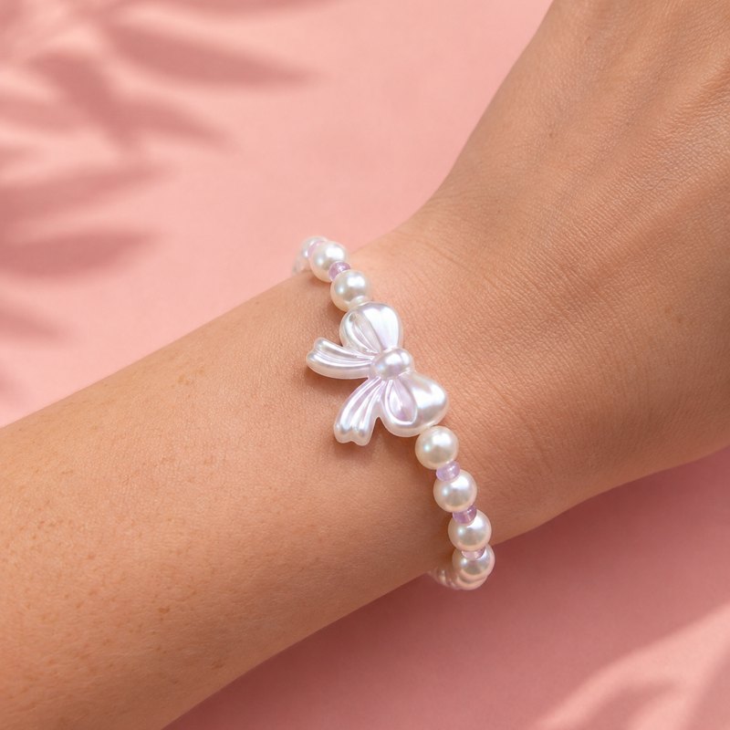 Limited Edition Bracelet with a bow charm, worn on the wrist